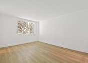 Thumbnail 49 of 56 - A room with a wooden floor and a painting on the wall.