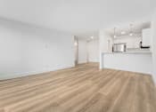 Thumbnail 13 of 56 - A room with wooden flooring and white walls.