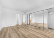 Thumbnail 17 of 56 - A room with a white wall and a wooden floor.