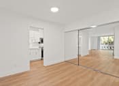 Thumbnail 35 of 56 - A room with a wooden floor and a glass door.
