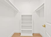 Thumbnail 39 of 56 - A white shelving unit in a white room.