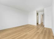 Thumbnail 8 of 56 - A room with wooden flooring and white walls.