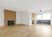 Thumbnail 9 of 19 - A room with a fireplace and sliding glass doors.