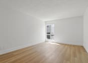 Thumbnail 15 of 19 - A room with wooden flooring and a window.
