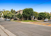 Thumbnail 29 of 29 - A street view with cars, trees, and buildings.