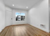 Thumbnail 1 of 29 - A room with wooden floors and white walls.