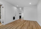Thumbnail 3 of 29 - A room with wooden floors and white walls.