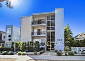 Thumbnail 1 of 2 - A modern building with the number 1128 on it.