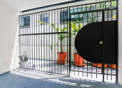Thumbnail 2 of 2 - a small cage with a door and a plant in it