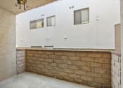 Thumbnail 5 of 12 - an empty room with a brick wall and a bar