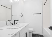 Thumbnail 9 of 12 - a bathroom with a sink and a toilet and a shower