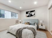 Thumbnail 3 of 32 - A bedroom with a large bed and a window.