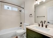Thumbnail 9 of 32 - a bathroom with a sink toilet and a bath tub