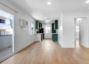 Thumbnail 23 of 32 - A room with wooden floors and white walls.
