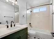 Thumbnail 28 of 32 - A bathroom with a white toilet and a white sink.