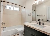 Thumbnail 18 of 32 - A white toilet with a star design on it is in a bathroom with a white tub and a sink.