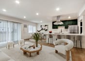 Thumbnail 1 of 29 - A modern living room with a white sofa set and a wooden coffee table.