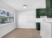 Thumbnail 18 of 29 - A kitchen with green cabinets and a white countertop.