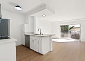 Thumbnail 1 of 21 - A kitchen with white cabinets and a black fridge.