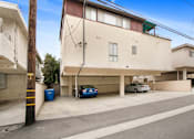 Thumbnail 21 of 21 - A blue car is parked in a garage.