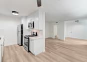 Thumbnail 14 of 23 - A kitchen with white cabinets and appliances.