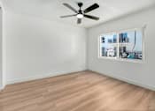 Thumbnail 9 of 23 - Empty room with a ceiling fan and a window.