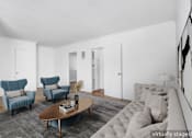 Thumbnail 3 of 17 - A living room with a grey rug and a brown coffee table.