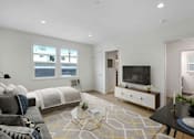 Thumbnail 1 of 21 - A modern bedroom with a large bed and a television.
