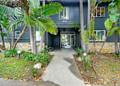 Thumbnail 14 of 22 - A house numbered 1830 is shown with a pathway leading to the front door.