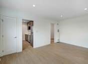Thumbnail 2 of 22 - A room with a white door and a white wall.