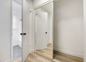 Thumbnail 19 of 22 - A white door with a mirror on the right side.