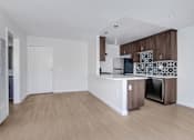 Thumbnail 14 of 37 - A kitchen with a white countertop and brown cabinets.