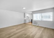 Thumbnail 1 of 37 - A room with wooden flooring and white walls.