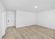 Thumbnail 2 of 37 - A room with wooden flooring and white walls.