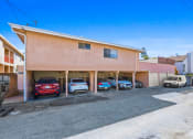 Thumbnail 12 of 12 - a parking lot with cars parked in front of a building