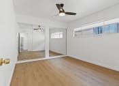 Thumbnail 7 of 12 - an empty living room with white walls and a ceiling fan