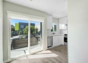 Thumbnail 3 of 47 - a sliding glass door leading into a kitchen with a view of a balcony