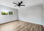Thumbnail 20 of 47 - an empty room with white walls and a ceiling fan