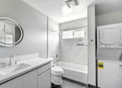 Thumbnail 32 of 47 - A white bathroom with a toilet, sink, and bathtub.