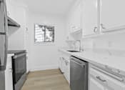 Thumbnail 5 of 23 - A modern kitchen with white cabinets and a marble countertop.