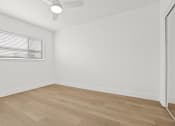 Thumbnail 15 of 39 - the living room of an apartment with wood flooring and a window