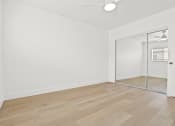 Thumbnail 16 of 39 - an empty room with a mirror and a closet