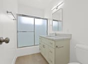 Thumbnail 17 of 39 - a white bathroom with a large window and a sink and toilet