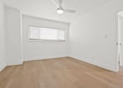 Thumbnail 18 of 39 - an empty room with hardwood floors and a window