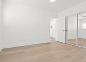 Thumbnail 19 of 39 - a living room with white walls and a sliding glass door
