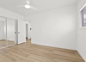 Thumbnail 10 of 39 - the living room of an apartment with white walls and wood flooring