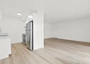 Thumbnail 2 of 39 - an empty living room and kitchen with white walls and wood floors