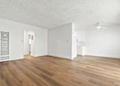 Thumbnail 31 of 39 - A room with wooden floors and white walls.