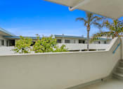 Thumbnail 22 of 39 - A white building with a blue sky in the background.