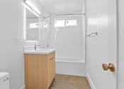 Thumbnail 26 of 39 - A bathroom with a sink, toilet, and shower.